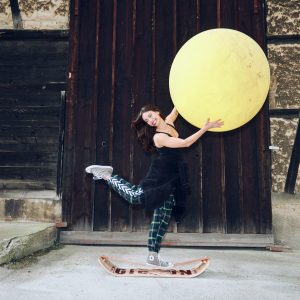 Giboard Roots Rocker Travel with a lady balancing on it