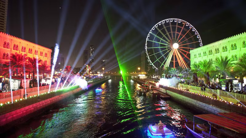 Families enjoying fireworks at Al Majaz Waterfront on UAE National Day