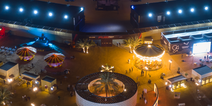Visitors enjoying the Liwa 2025 festival events, including cultural performances and motorsports.