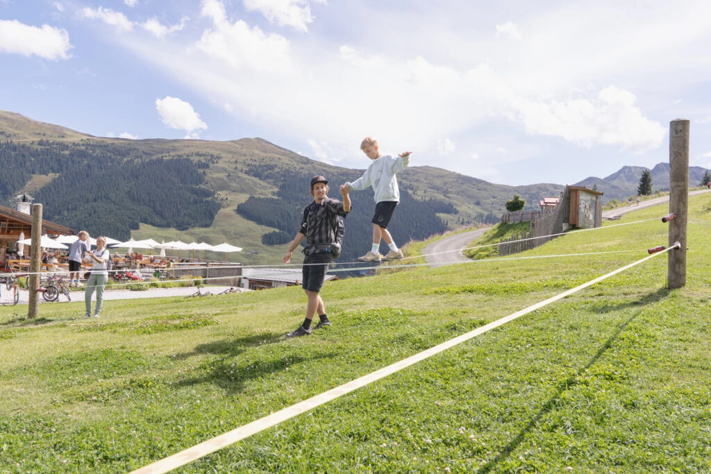 Children practicing slacklining in a park, improving coordination and balance Slackline in the UAE.