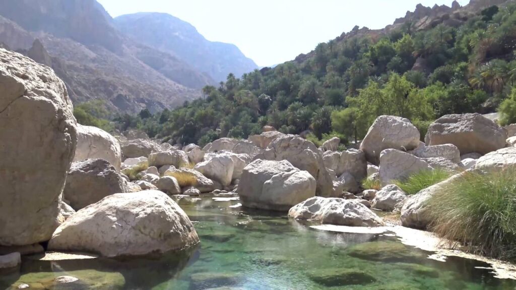 Lush valleys and dramatic cliffs along the peaceful Wadi Tiwi hiking trail in Oman