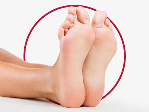 A person washing feet with antibacterial soap to prevent shoe odor.