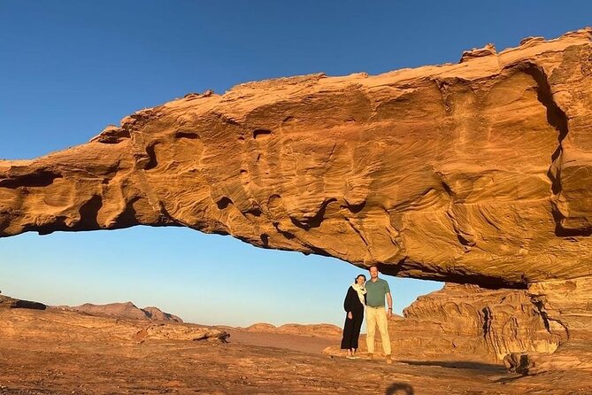 Serene Wadi al-Disah in Tabuk, surrounded by towering sandstone cliffs and flowing streams, ideal for family-friendly hiking in Saudi Arabia.
