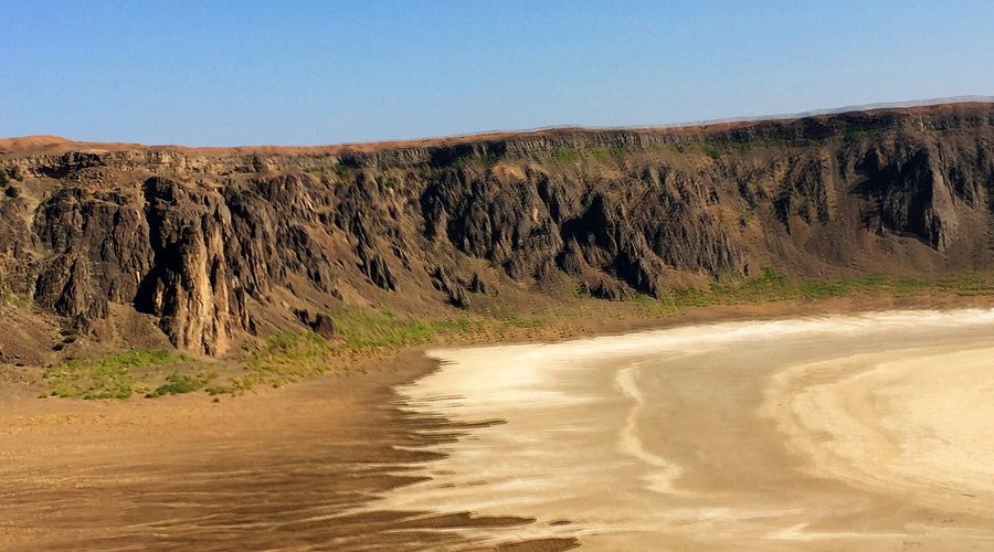 A stunning aerial view of Al Wahba Crater, a volcanic wonder with white salt flats, perfect for adventure and hiking in Saudi Arabia.