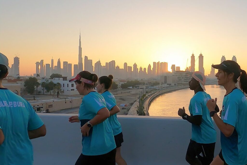 Runners participating in the Burj2Burj Half Marathon 2025, racing between Dubai's famous landmarks.