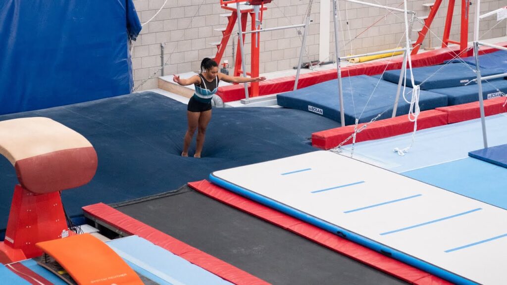 Gymnast landing in a foam pit, illustrating the risks of foam pit injuries due to hidden hard surfaces and hygiene concerns.