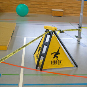 a yellow slackframe in a gym