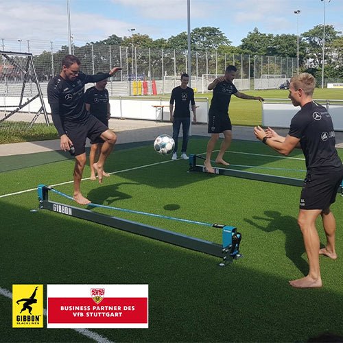 Football squad members using slacklines to enhance coordination and stability.