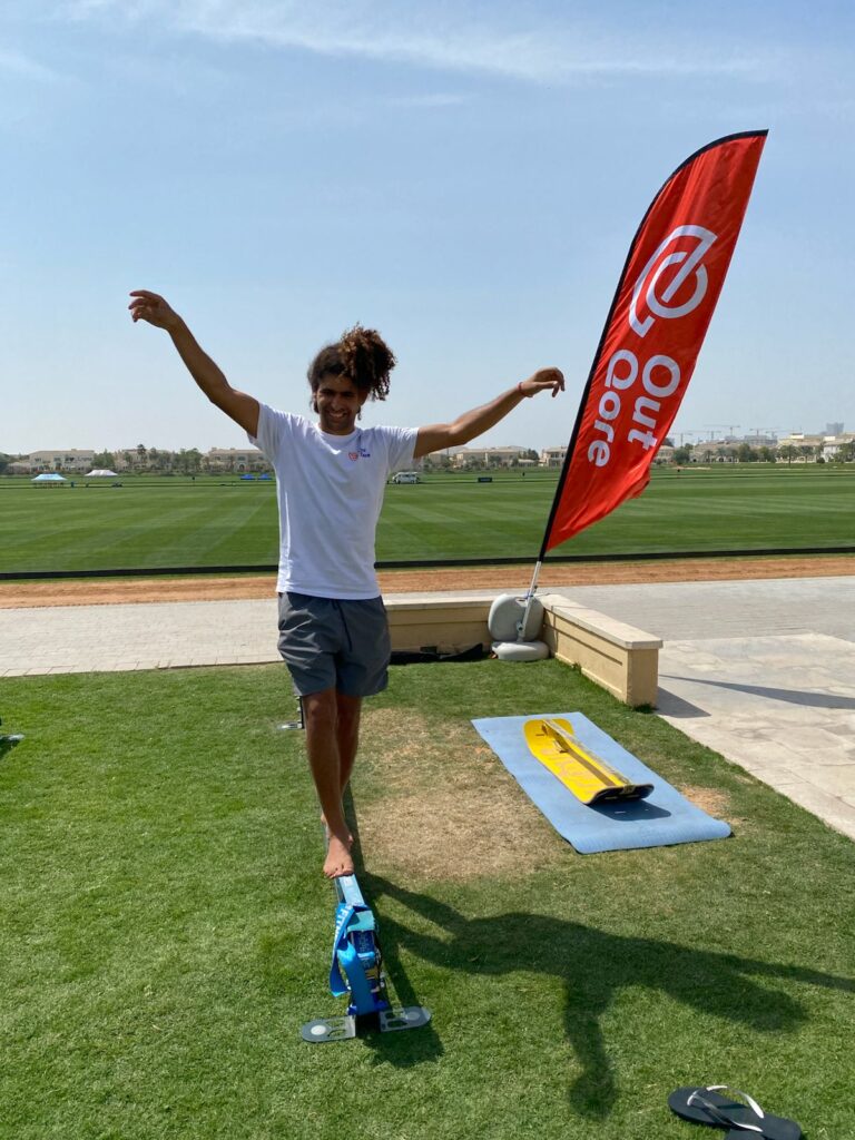 A fitness enthusiast practicing slackline tricks, improving slackline balance and coordination