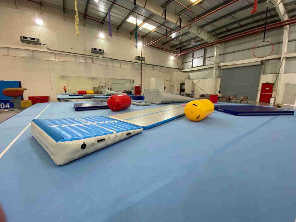 Gym setup in Dubai with multiple AirTrack mats and AirRolls for professional gymnastics training.