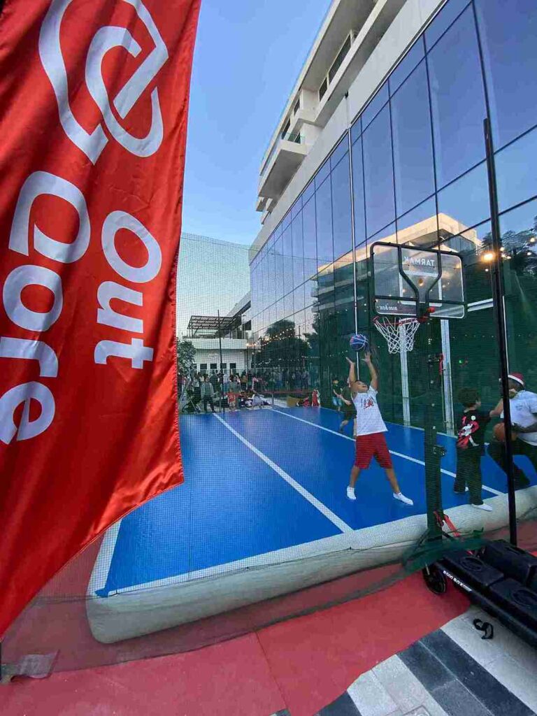 Child playing basketball on an AirTrack mat at an OutQore event in Dubai, highlighting family-friendly training.