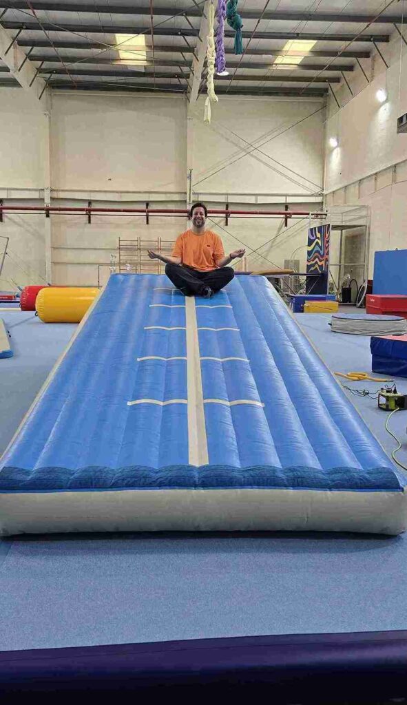 Person meditating on an AirTrack mat in a Dubai gym, showcasing versatility for yoga and training.