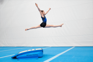 a girl jumping in the air with split open legs