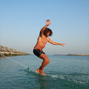 a man on a slackline in the water